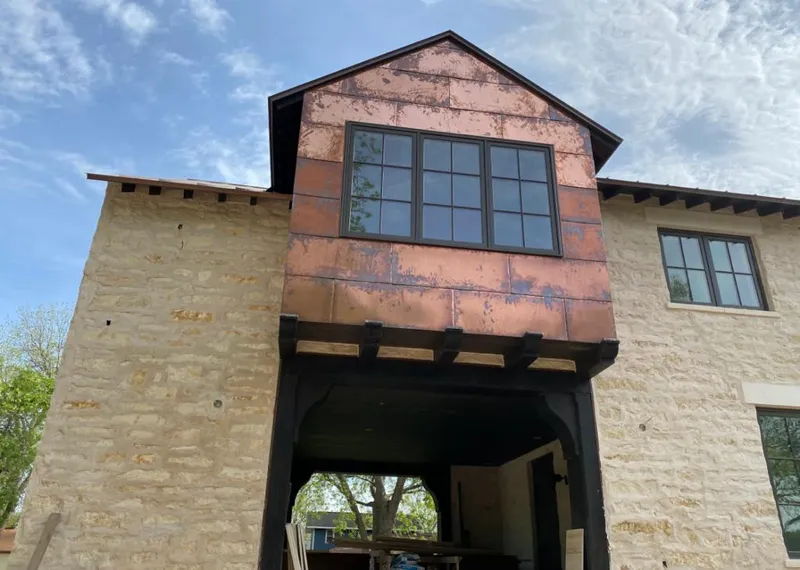 Copper metal panel facade on a stone building for Roof Repair in Richmond Heights
